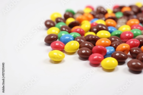 Close-up of colorful candies spread on a sleek white background