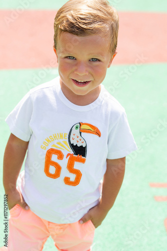 Smiling Child in Summer Outfit on Colorful Background photo