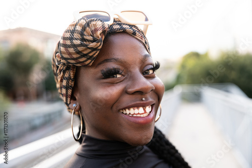 Joyful portrait of young black woman with stylish headscarf photo