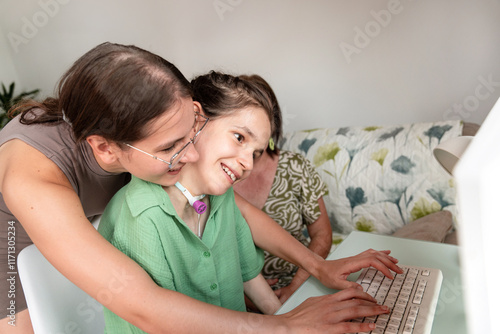 Family enjoying together with a disabled girl using a computer at home