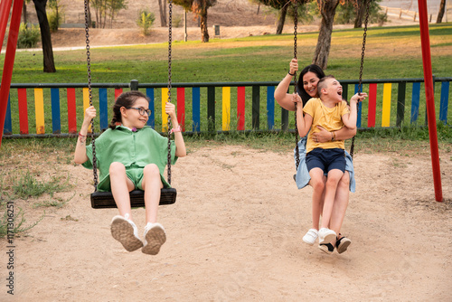 Family enjoying a playful day at the park, full of smiles and swings photo