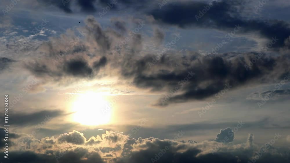The sun is setting behind the clouds. The sun is setting behind the clouds.