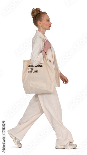 Fashionable woman in a beige suit and carrying a tote bag walking in profile side towards the camera isolated on transparent background