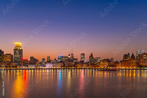 sunset or sun rise of Historical architecture on the bund of Shanghai with reflection of buildings in city Shanghai, China photo