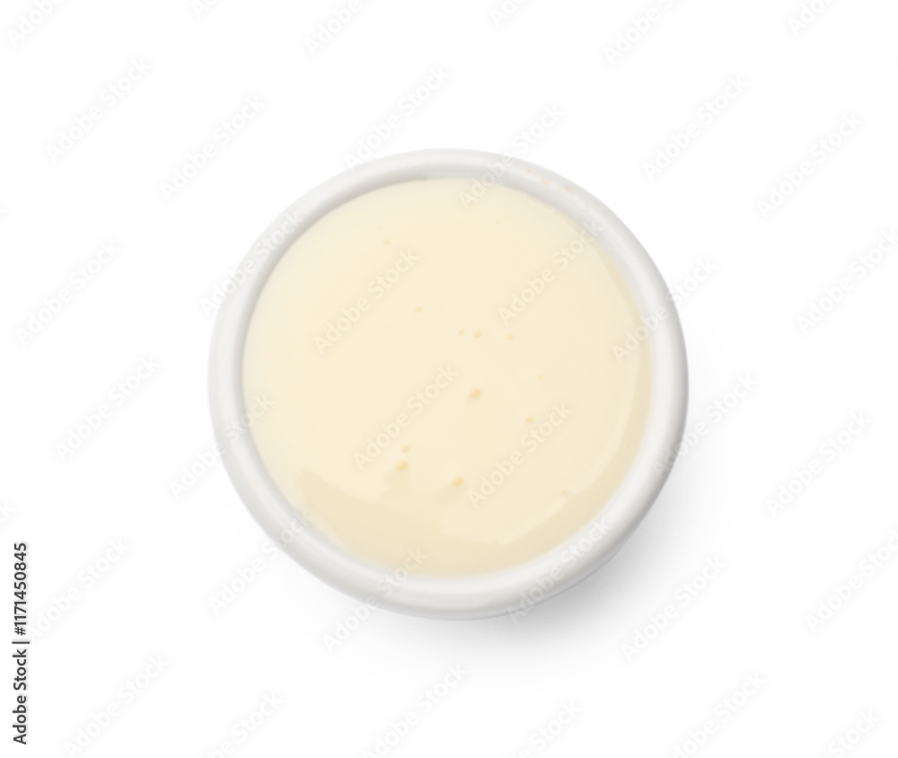 Condensed milk in bowl isolated on white, top view Condensed milk in bowl isolated on white, top view