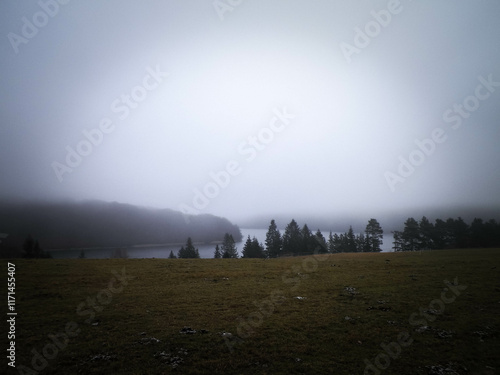 Foggy day in Krzeszna, Ostrzyckie lake and Wiezyca hills Poland photo