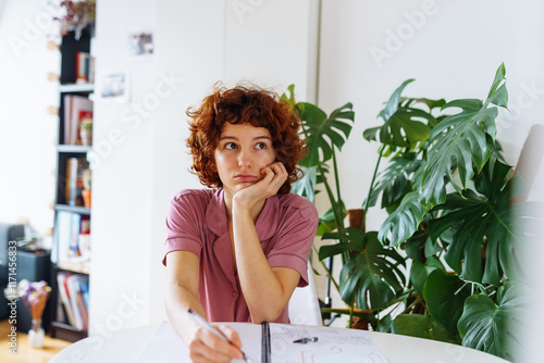 homeschooling, woman writing notes in notebook photo