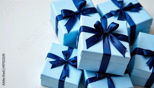 Elegant blue presents with dark blue bows stacked on a white background