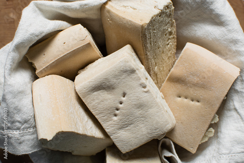 Overhead view of hardtack bread on a wood chopping board, top view of nigerian hardtack also known as kpo kpo madiga