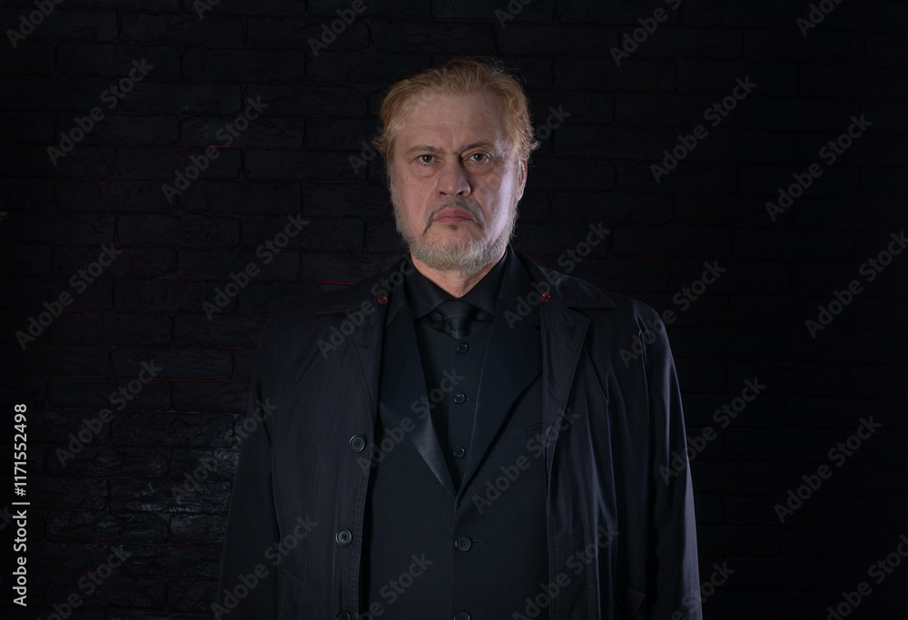 Fototapeta premium close-up portrait of an old man in a black classic suit