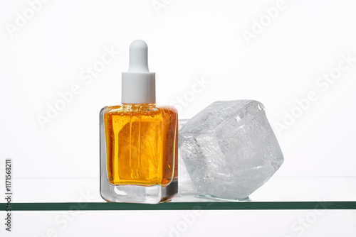 Vitamin C Serum Bottle with Ice Cube for Skincare Theme photo