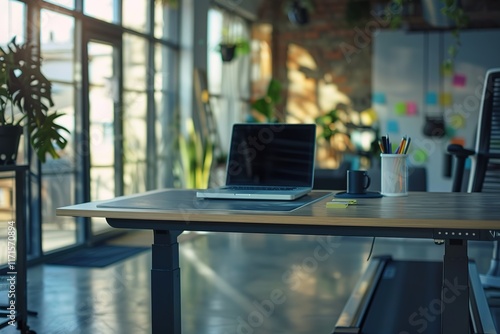 Modern workspace with laptop on adjustable standing desk. photo