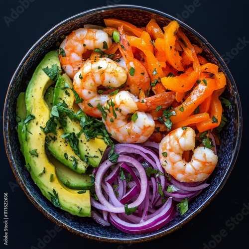 Fresh shrimp salad with avocado and colorful vegetables in a bowl