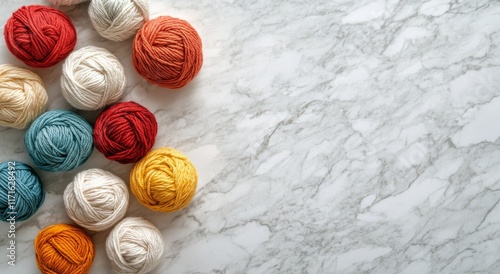 Colorful yarn balls arranged on a marble surface for creative textile projects