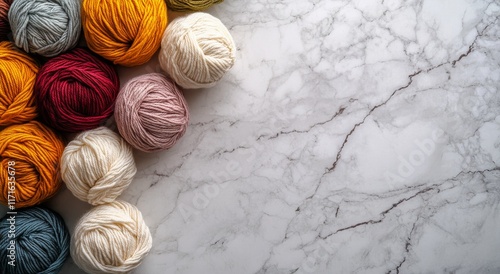 Colorful yarn balls arranged on a marble surface for creative textile projects