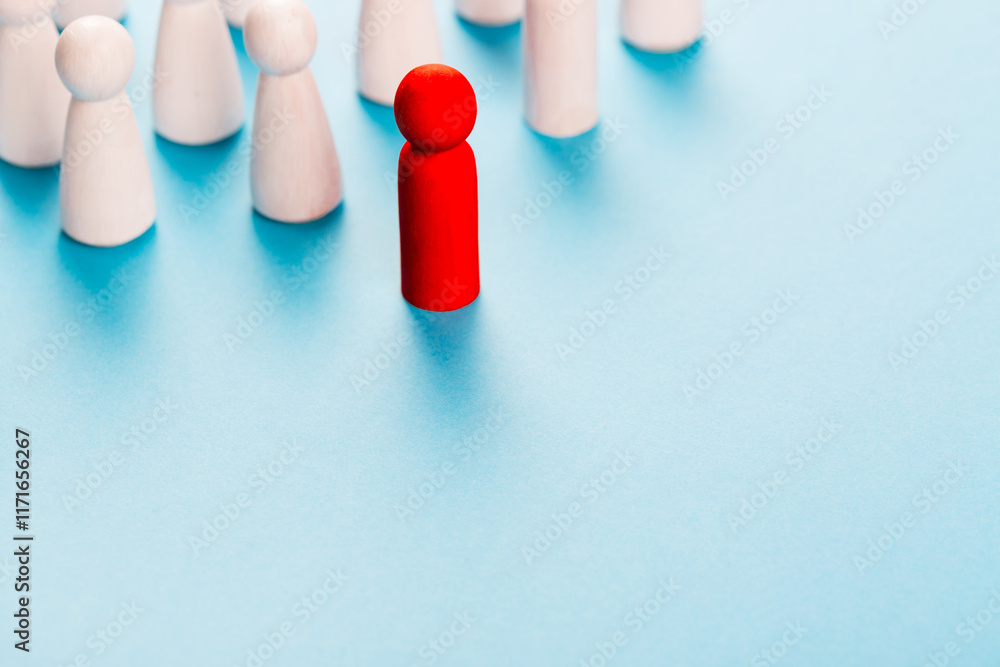 Leadership in business concept. Red human figurine near white human figurines. Director and employees of the company Leadership in business concept. Red human figurine near white human figurines. Director and employees of the company