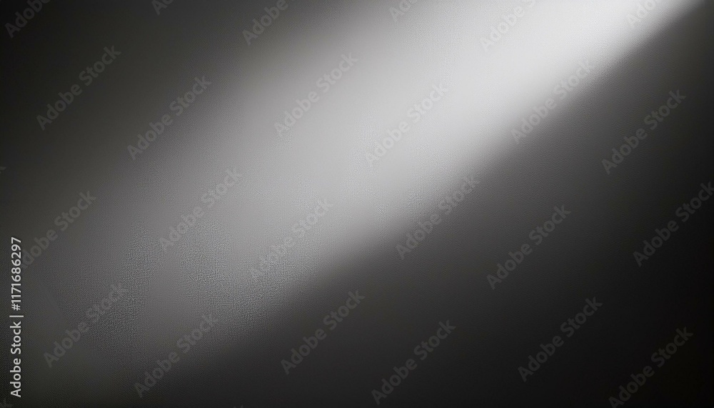Dramatic light beam across a textured gray surface. Monochromatic, moody, and atmospheric. Dramatic light beam across a textured gray surface. Monochromatic, moody, and atmospheric.