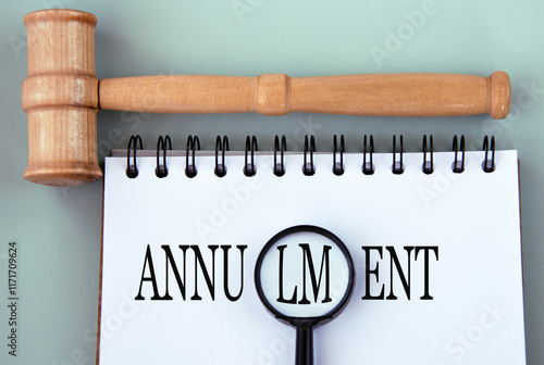 ANNULMENT - word in a notebook on a gray background with a judge's gavel