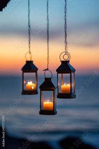 Beautiful lanterns with candles hang above the ocean during sunset in a tranq...