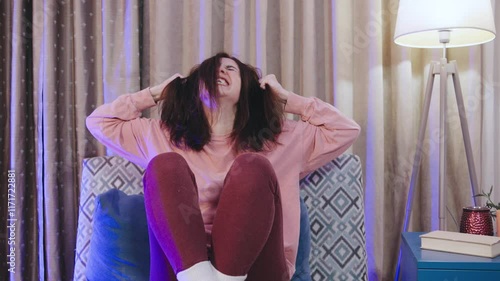 Young woman screams in hysterics and pulls out her hair from despair, anger, sadness and loneliness