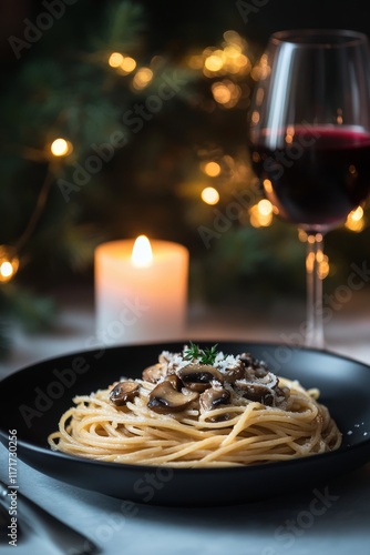 Romantic dinner with spaghetti and wine by candlelight in an elegant setting