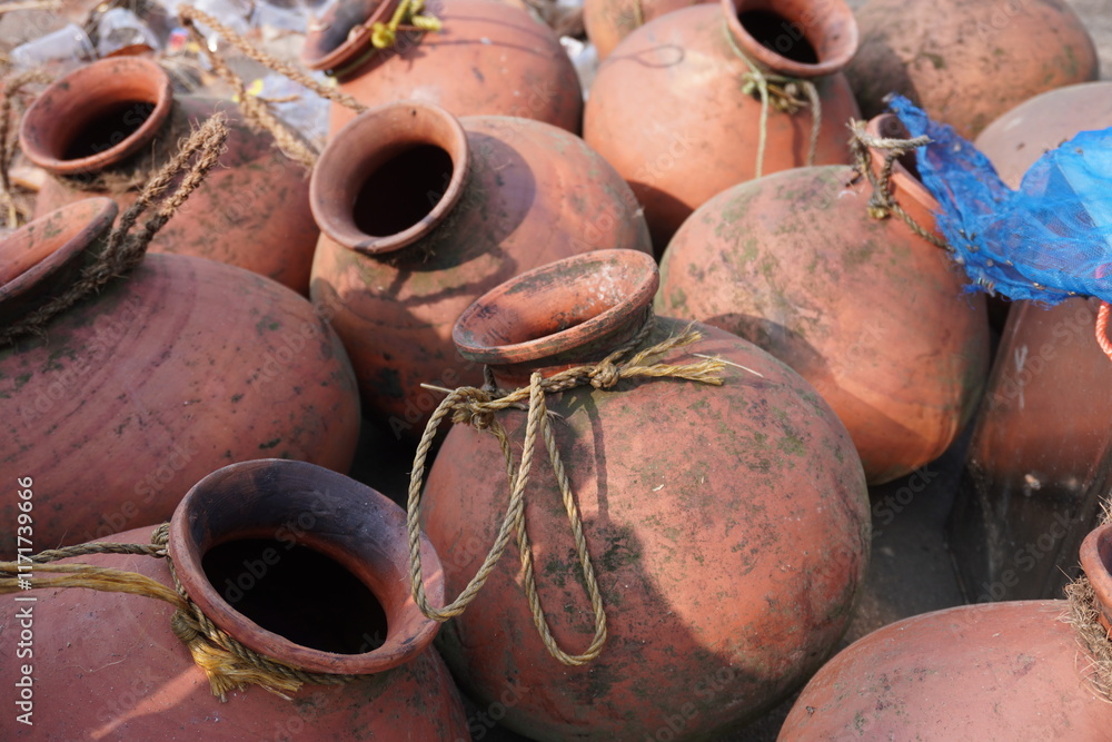 Clay pots full of date juice kept in a place Clay pots full of date juice kept in a place