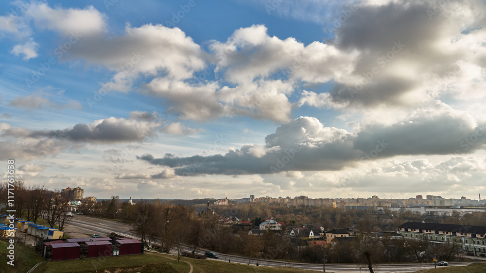 Obraz premium Panoramic view of the city on a sunny summer day. A road bridge crosses the river in the city.