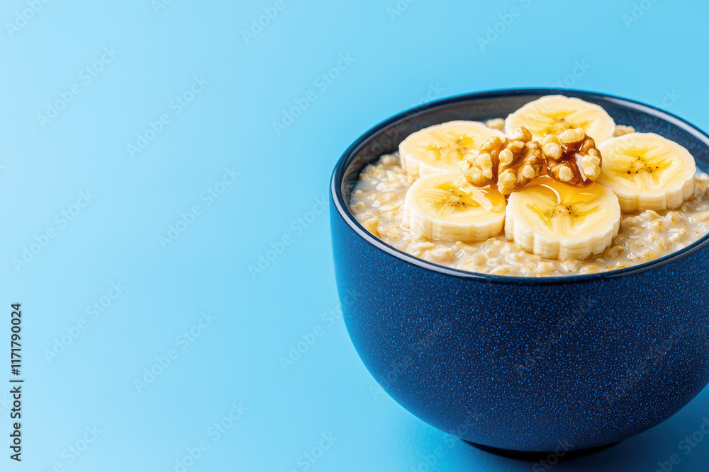 Creamy oatmeal bowl with banana slices and walnuts Creamy oatmeal bowl with banana slices and walnuts