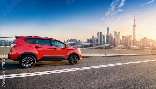 modern red suv driving on bridge with city skyline in background