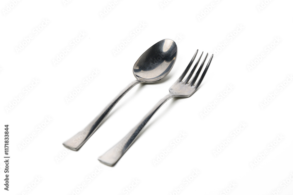 Elegant fork and spoon arranged on a white surface for a minimalist dining experience Elegant fork and spoon arranged on a white surface for a minimalist dining experience
