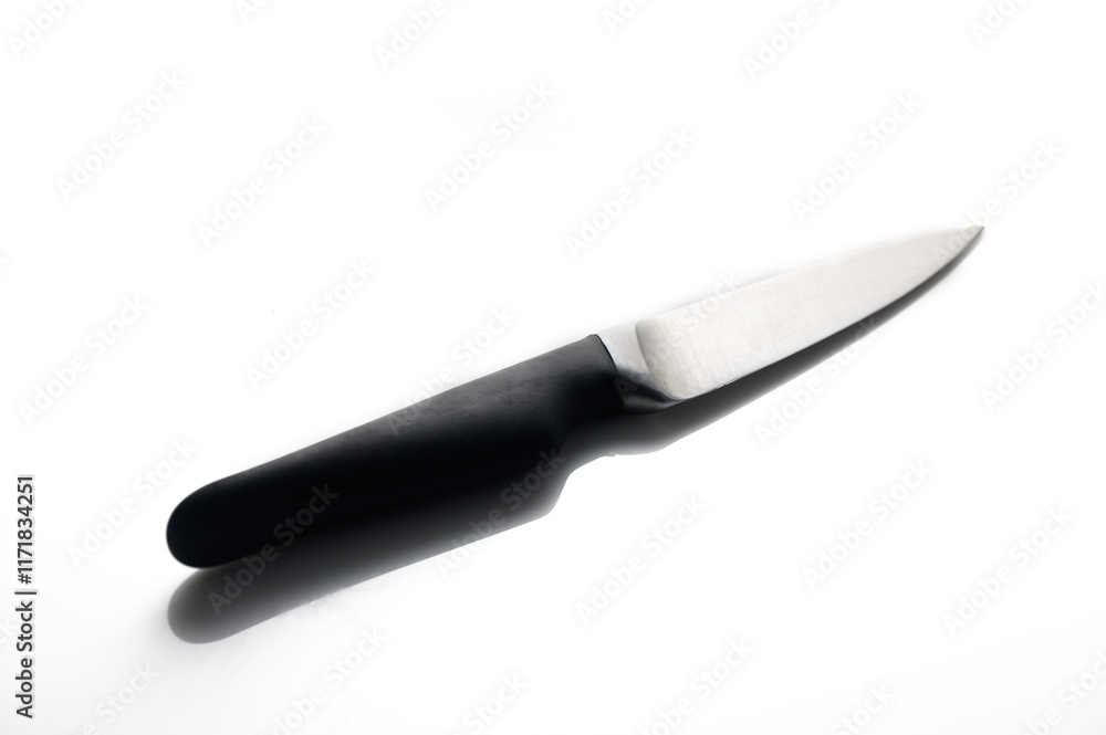 Sharp kitchen knife resting on a clean surface in bright light during morning preparation Sharp kitchen knife resting on a clean surface in bright light during morning preparation