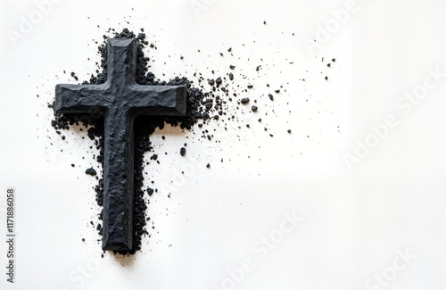 Dark grey crucifix made of ash rests on white background. Ash wednesday symbol. Religious holiday concept. Spiritual symbol of faith, repentance. Image for faith based blog website. Creative photo photo