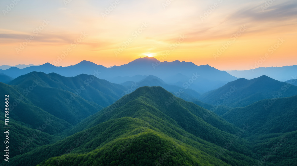 Fototapeta premium Majestic mountain range covered in lush greenery with a glowing sunrise