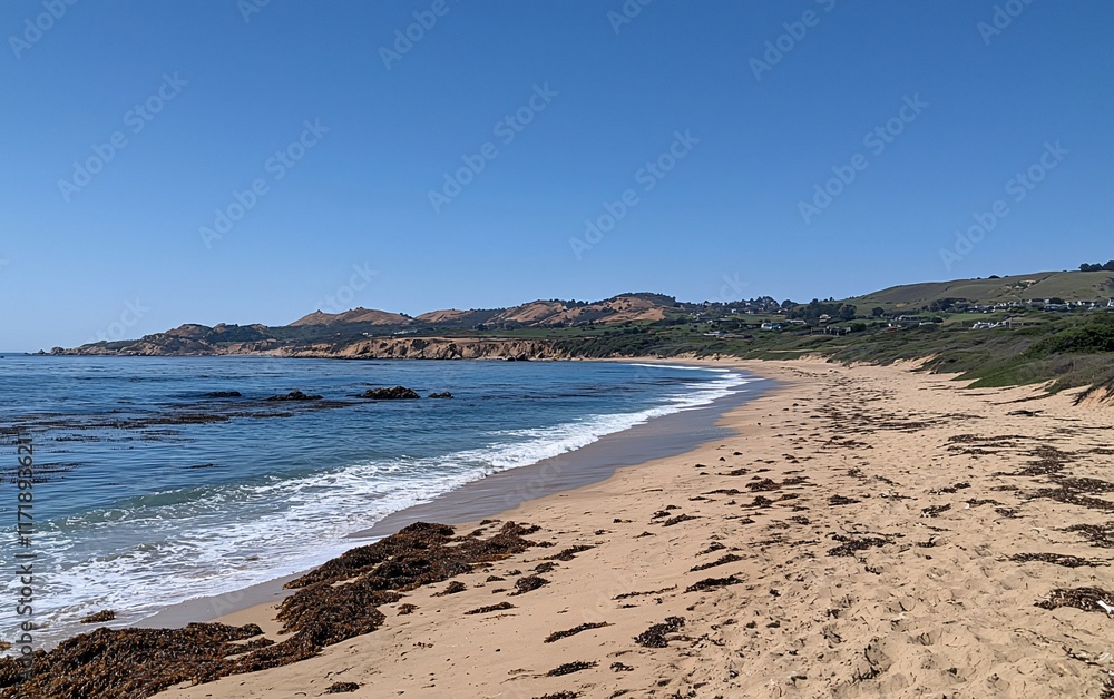 Serene coastal scene sandy beach, ocean waves, rocky shore, clear sky, and distant hills. Serene coastal scene sandy beach, ocean waves, rocky shore, clear sky, and distant hills.
