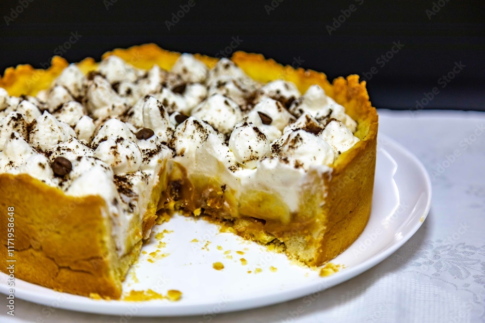 Traditional banoffee cake with banana and caramel sauce filling sprinkled with grated dark chocolate and coffee . English traditional pie Traditional banoffee cake with banana and caramel sauce filling sprinkled with grated dark chocolate and coffee . English traditional pie