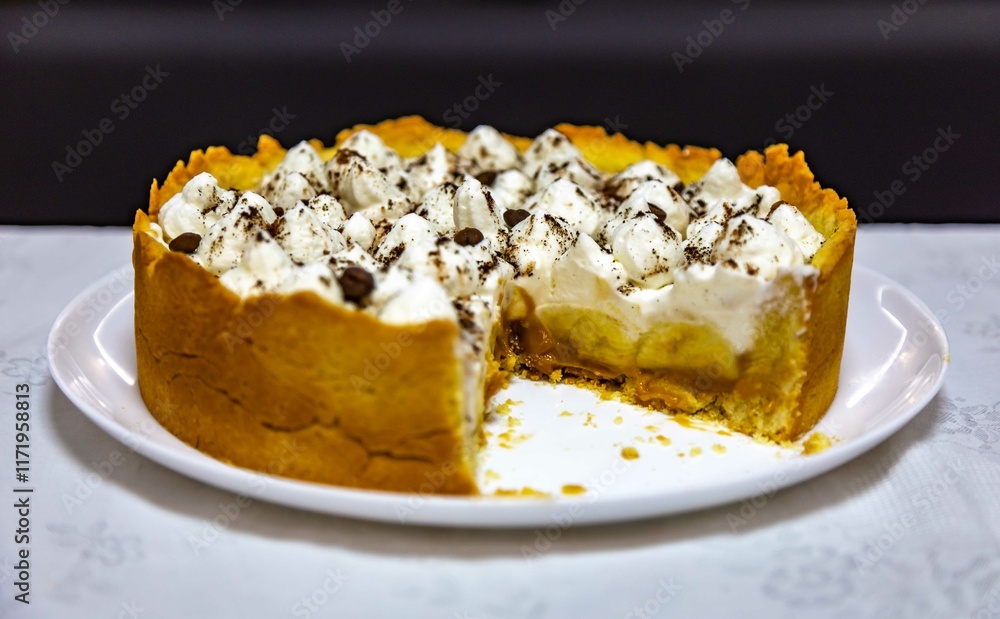 Traditional banoffee cake with banana and caramel sauce filling sprinkled with grated dark chocolate and coffee . English traditional pie Traditional banoffee cake with banana and caramel sauce filling sprinkled with grated dark chocolate and coffee . English traditional pie