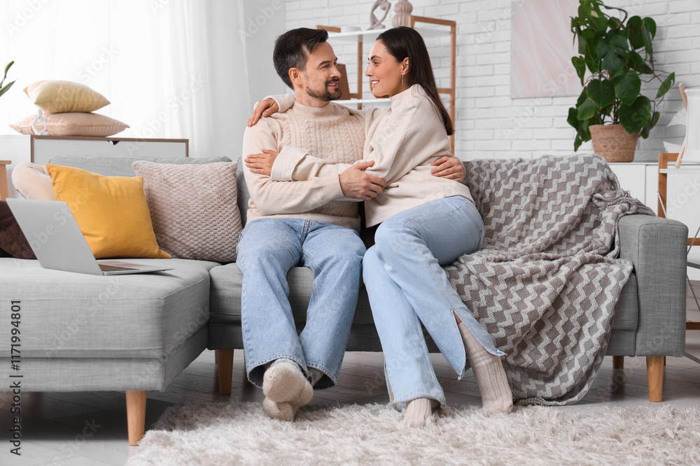 Obraz premium Young couple hugging at home on autumn day