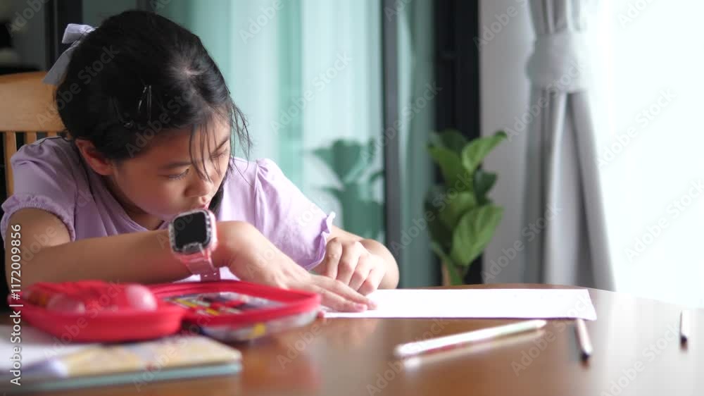 Asian Elementary School Girl Studying at Home: A Concept of Education and Learning Asian Elementary School Girl Studying at Home: A Concept of Education and Learning