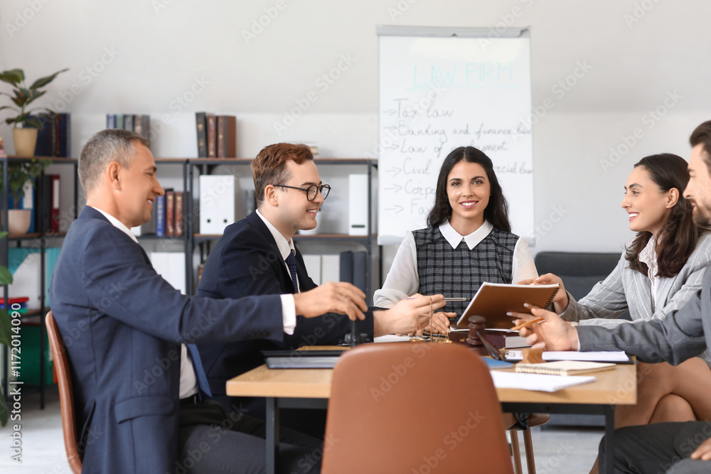 Group of lawyers working at table in office Group of lawyers working at table in office