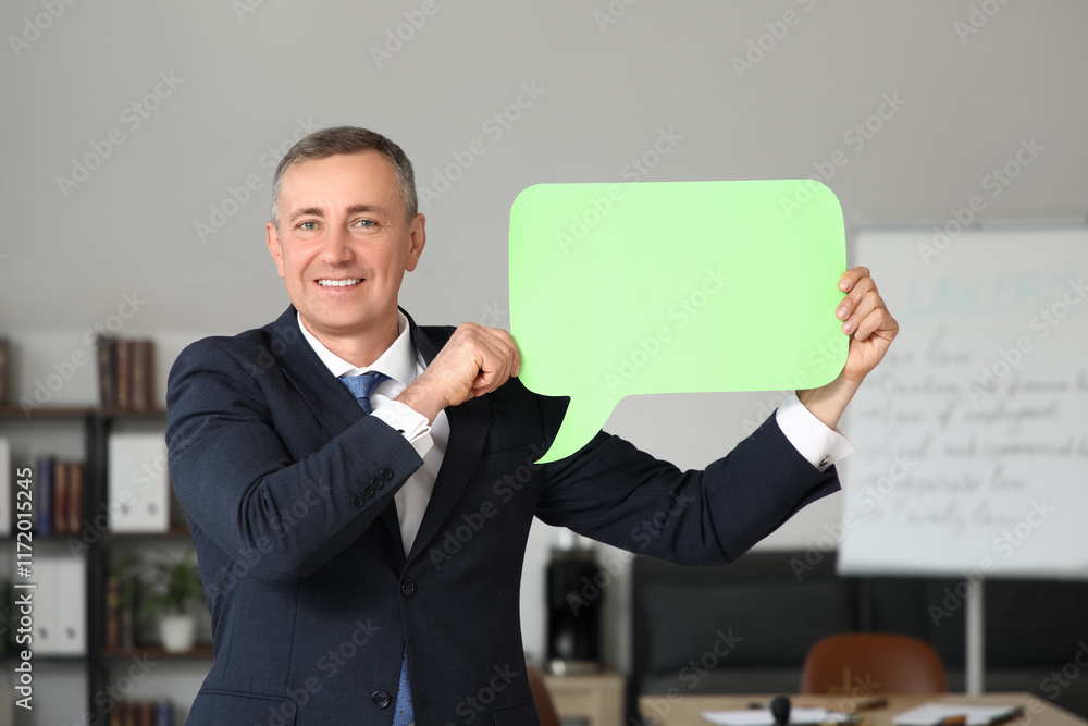 Mature businessman with blank speech bubble in office Mature businessman with blank speech bubble in office