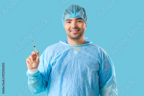 Male doctor with syringe on...