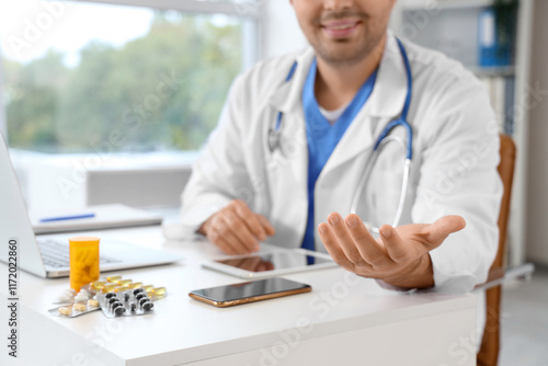 Male doctor at workplace in...