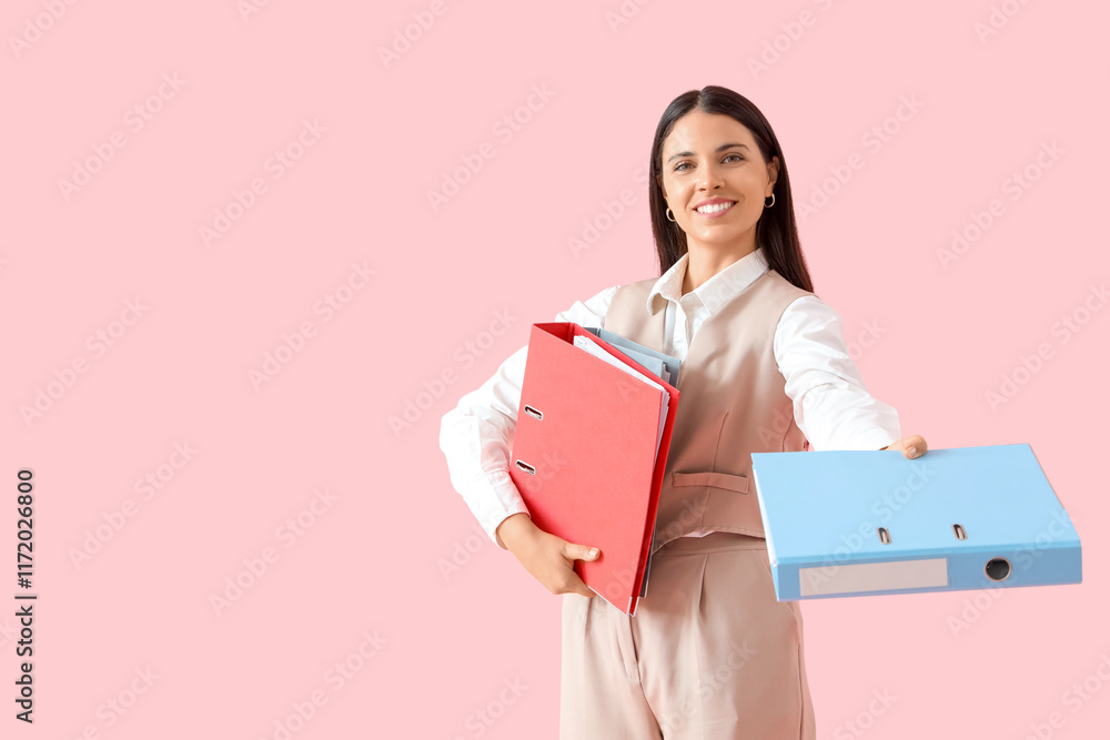 Young businesswoman with folders on pink background Young businesswoman with folders on pink background