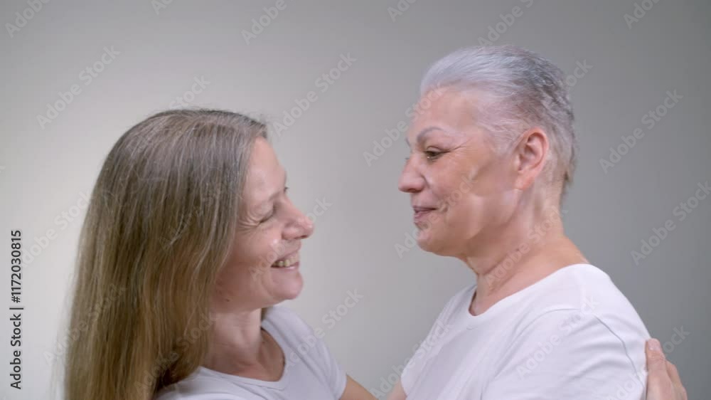 Close up portrait two old women hugging. Family monogamous love of the same sex. Gender self identification. Senior females are laughing and happy, smiling. Older mother, relationship, support or care Close up portrait two old women hugging. Family monogamous love of the same sex. Gender self identification. Senior females are laughing and happy, smiling. Older mother, relationship, support or care