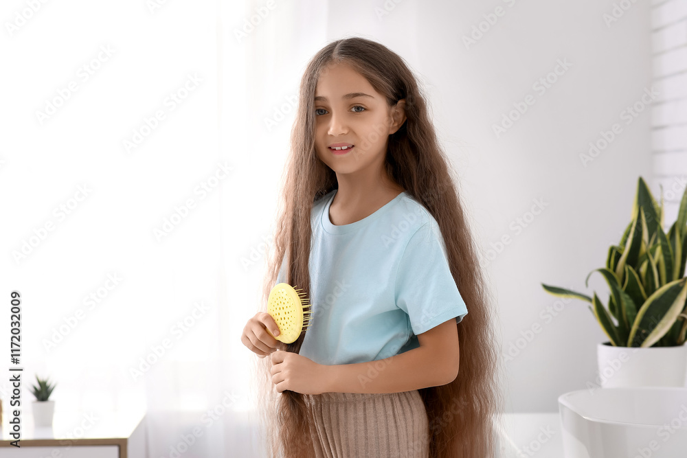 Cute little girl brushing her hair in bathroom Cute little girl brushing her hair in bathroom