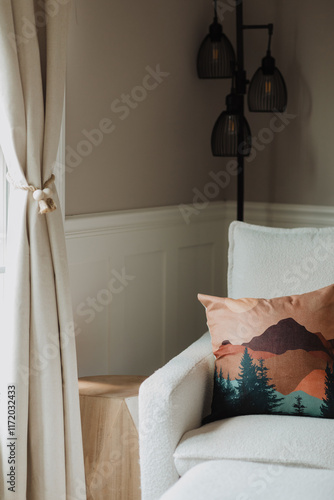 Cozy Reading Nook with Minimalist Lighting and Mountain Landscape Pillow for a Serene Home Decor Inspiration