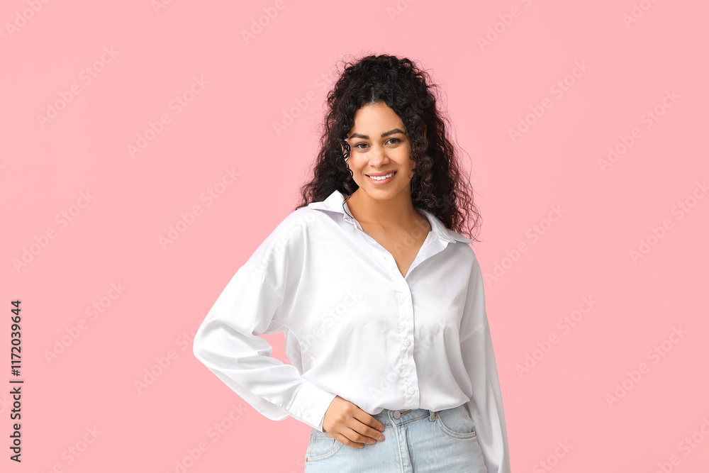 Pretty young African-American woman in stylish white shirt on pink background Pretty young African-American woman in stylish white shirt on pink background