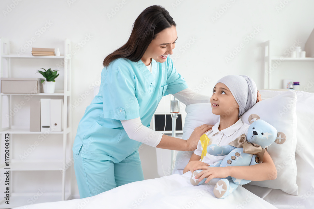 Little girl after chemotherapy with yellow ribbon and nurse in clinic. Childhood cancer awareness concept Little girl after chemotherapy with yellow ribbon and nurse in clinic. Childhood cancer awareness concept