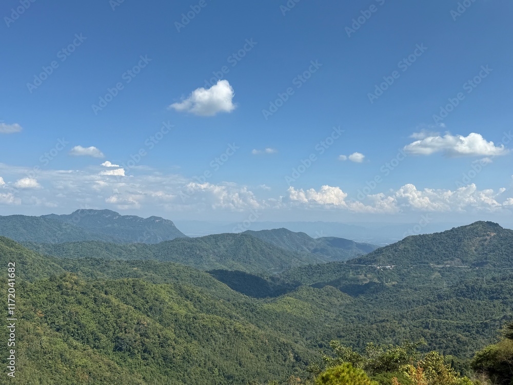 Fototapeta premium Serene Mountain Panorama Under a Blue Sky