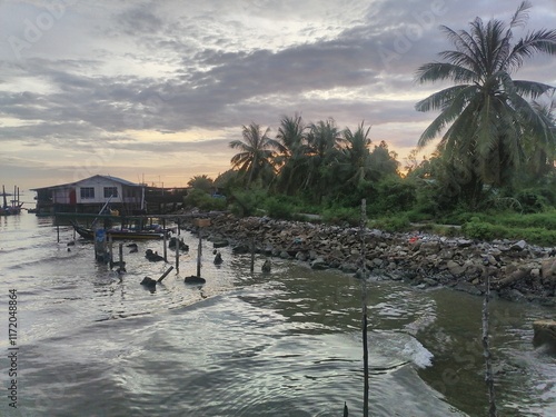 Photo of granite rock as a breakwater at the mouth of the Kurau river, Perak, Malaysia photo